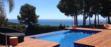 An infinity pool, sun loungers