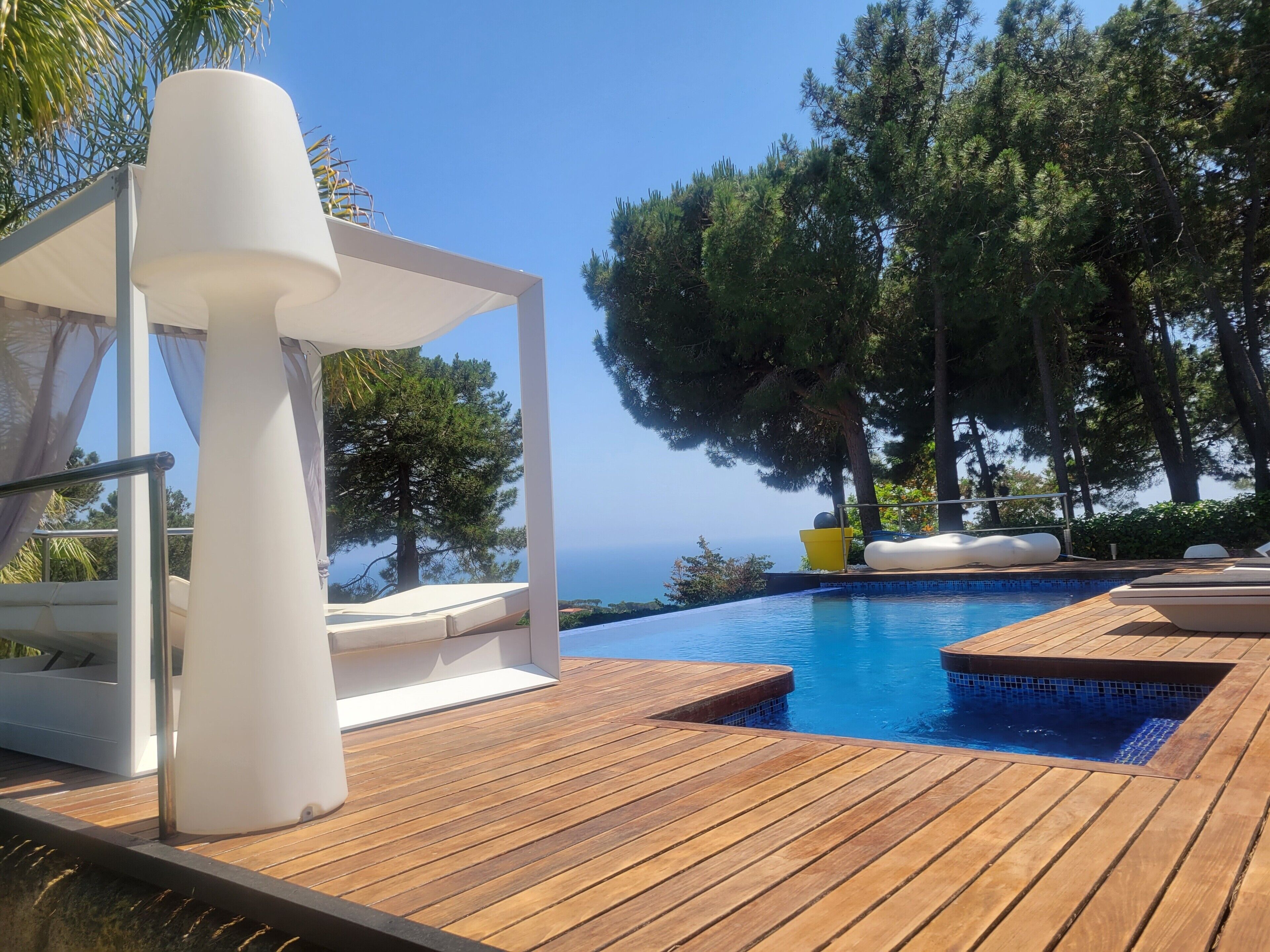 An infinity pool, sun loungers