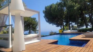 An infinity pool, sun loungers