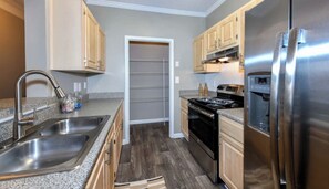 Enjoy cooking in this well-equipped kitchen with a refrigerator, oven, and double sink.