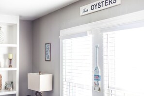 A room with a white lamp, a framed picture, and a sign reading "Fresh Oysters" on the wall. - Water View & Access, Game Room~Sunrise~Beach~Kayak Fishing Sleeps 6 (Smyrna)
