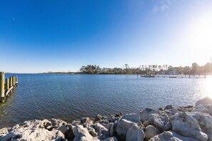 A calm lake with a rocky shoreline and a pier extending into the water. - Water View & Access, Game Room~Sunrise~Beach~Kayak Fishing Sleeps 6 (Smyrna)