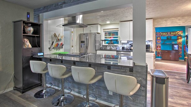 A modern kitchen with a central island, bar stools, and a built-in refrigerator. - Big-Screen Ducks Nights, Autzen Stadium 4 Mi Away (Springfield)