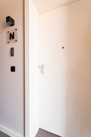 A white door with a keyhole and a lock.