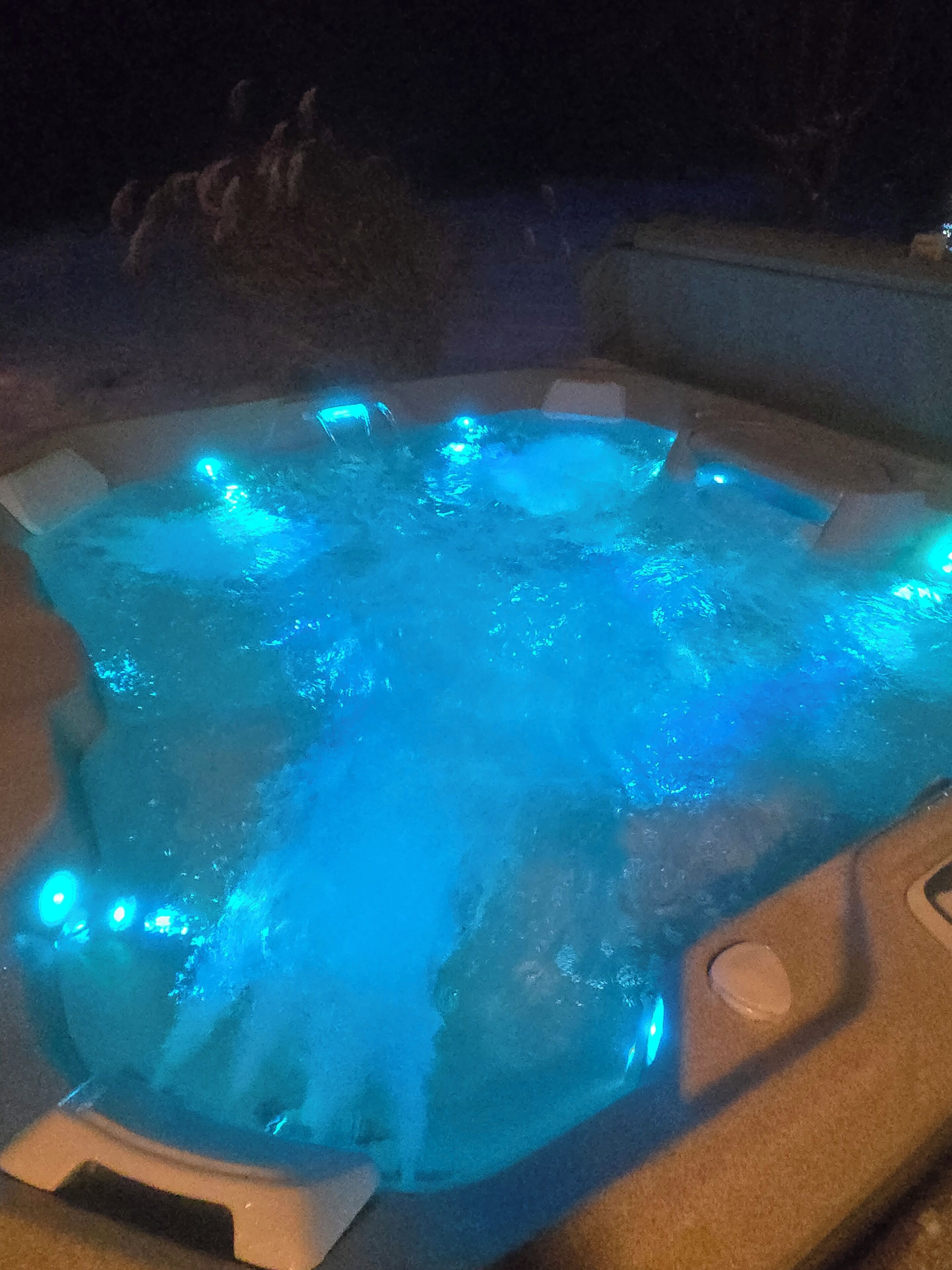 A hot tub with blue LED lights.