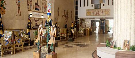 A spacious lobby with Egyptian-themed decor, including statues and wall art.
