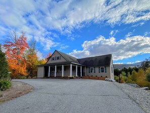 Set amidst a serene landscape, this charming home offers a peaceful retreat with a front porch and a beautifully landscaped yard.