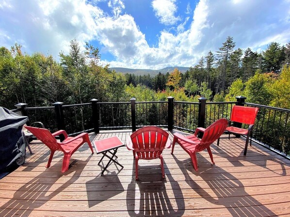 Enjoy a barbecue on the deck with a view of the surrounding forest and distant mountains.