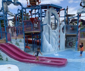 Kids can splash and play in this multi-level water play area with slides and water jets.