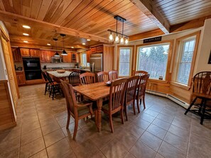 Enjoy cooking in this well-equipped kitchen with a large island, double oven, and dining area.
