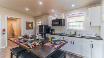 Fridge, microwave, coffee/tea maker, cookware/dishes/utensils