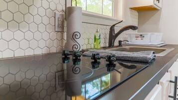 Fridge, microwave, coffee/tea maker, cookware/dishes/utensils