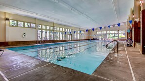 An indoor swimming pool with clear lanes, a lifeguard chair, and a windowed wall. - PicoVillage Resort G301-Beautiful contemporary style 2-bedroom,2-bath condo with the comfort of home (Killington)