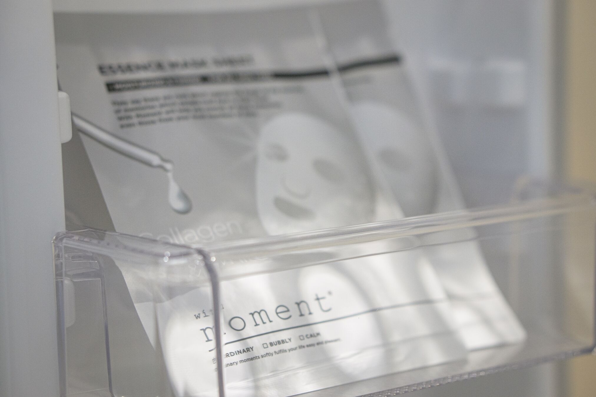 A clear plastic storage box with a label that reads "moment."