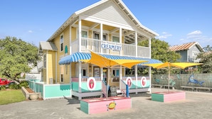 A creamery with a colorful exterior, a covered porch, and a signboard. - Steps to pool/gated community-4 free bikes-beach toys-backyard/now 2 king beds  (Santa Rosa Beach)