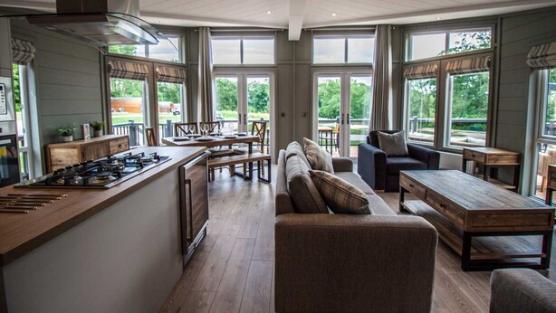 A spacious kitchen with a central island, dining area with a long table and chairs, and a seating area with sofas and a coffee table. - Maple Lodge | sleeps 6 - Hot Tub, Dog Friendly - 5* Visit England (Pickering)