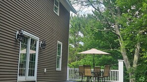 A house with a covered patio, a lawn, and a tree. - Name: Hill Crest<br>Private Setting. Heated Pool. 4 Minutes to Dreams Park  (Cooperstown)