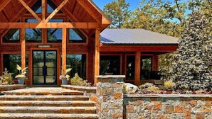 A lodge with a wooden exterior and a stone entrance, labeled "Beavers Bend Safari Park."