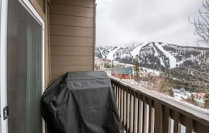 A balcony with a view of a snow-covered mountain.