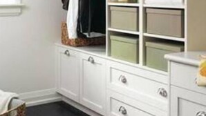 A walk-in closet with white cabinetry, multiple drawers, and shelves for storage. - Port Credit - Mineola Cottage (Mississauga)