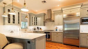 A modern kitchen with grey cabinetry, stainless steel appliances, and a central island. - The Gideon Lowe House - Old Town Key West  (Key West)