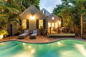 A house with a swimming pool, wooden deck, and lounge chairs. - The Gideon Lowe House - Old Town Key West (Key West)