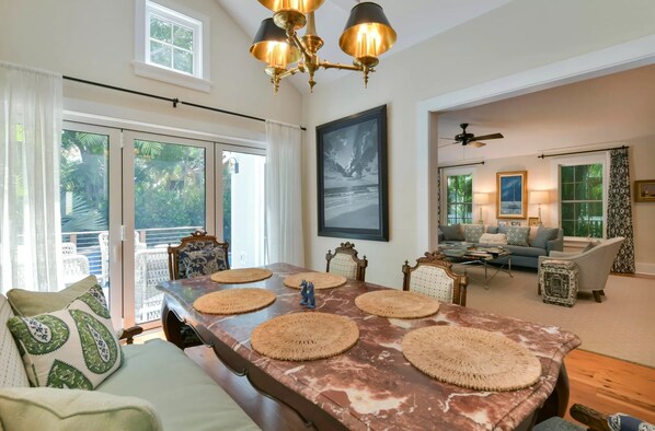 A spacious living area with a large marble table, comfortable seating, and a ceiling fan. - The Gideon Lowe House - Old Town Key West (Key West)