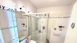 A modern bathroom with a glass shower enclosure, a white sink, and a toilet. - Herring Gull - Fantastic sea view (Cuxhaven)