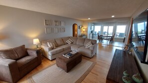 Relax in this inviting living space with a large L-shaped sofa, loveseat, and coffee table.