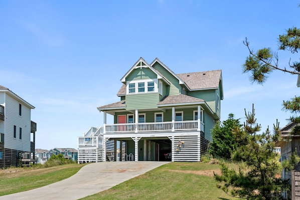 A two-story house with a balcony and a garage.