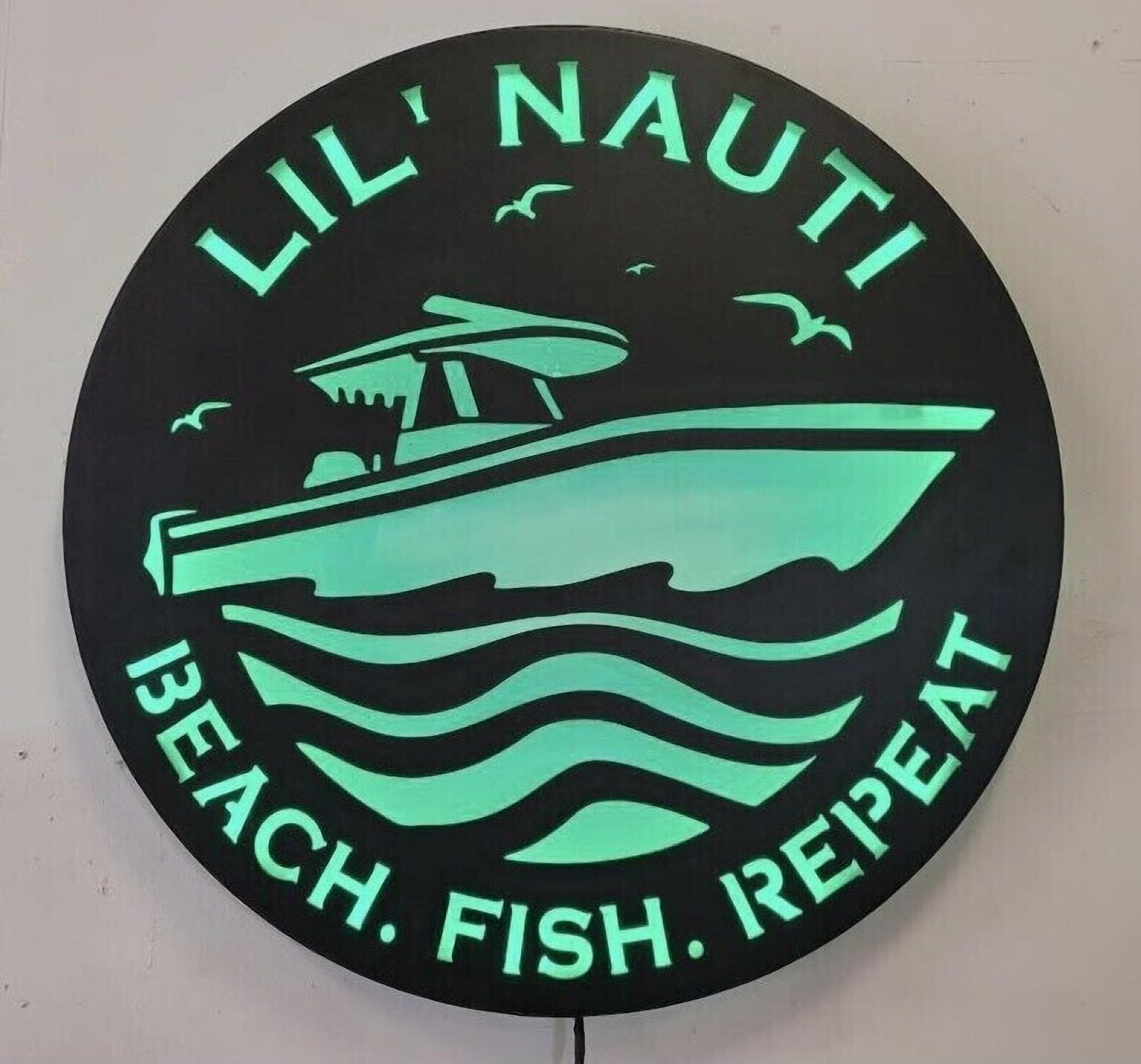A circular sign with the text 'LIL' NAUTI BEACH. FISH. REPEAT' and a graphic of a boat on water.