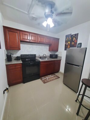 Fridge, microwave, stovetop, coffee/tea maker