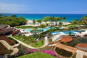 A resort with multiple swimming pools, a beach, and a large building with a curved roof. - 20% OFF til Dec 18 Beachfront Unit-Steps to Hapuna Beach, Big Lanai, Plunge Pool (Kamuela)
