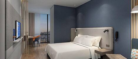 A modern hotel room with a large bed, a desk, a chair, and a TV.