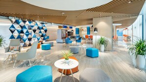 A modern lobby with geometric wall patterns, seating areas, and a reception desk. - Holiday Inn Express Yangjiang City Center by IHG (Yangjiang)