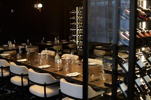 A dining area with a long table set for a meal, surrounded by chairs. - The Rockefeller Hotel by Newmark (Cape Town)