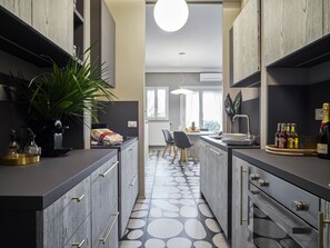 Fridge, stovetop, dishwasher, coffee/tea maker