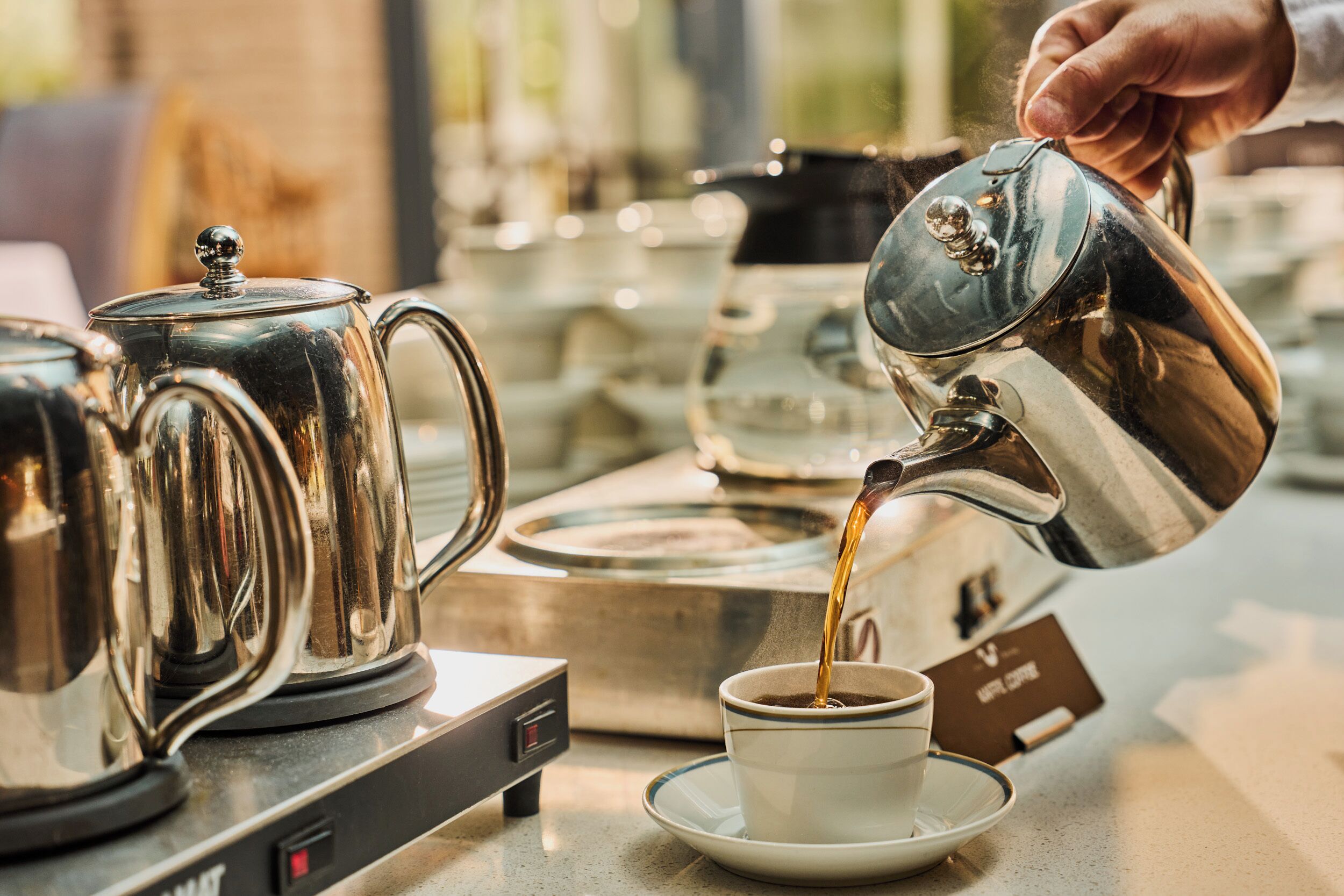 A coffee machine dispensing coffee into a cup.
