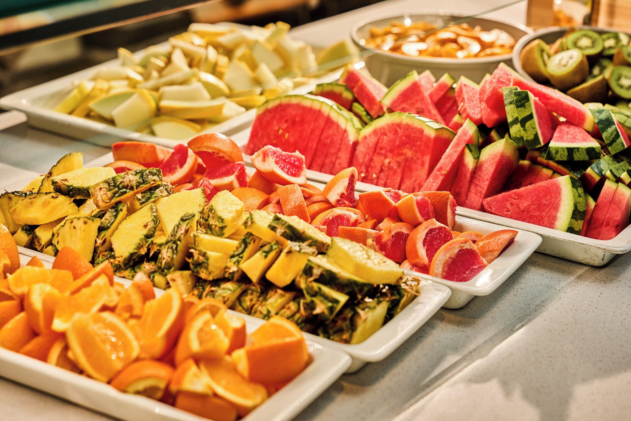 A buffet with various fruits and vegetables.