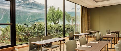 A conference room with large windows offering a mountain view.