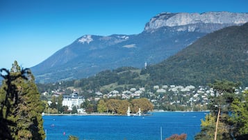 Une ville côtière, avec une montagne imposante en arrière-plan, un plan d’eau et des immeubles résidentiels.