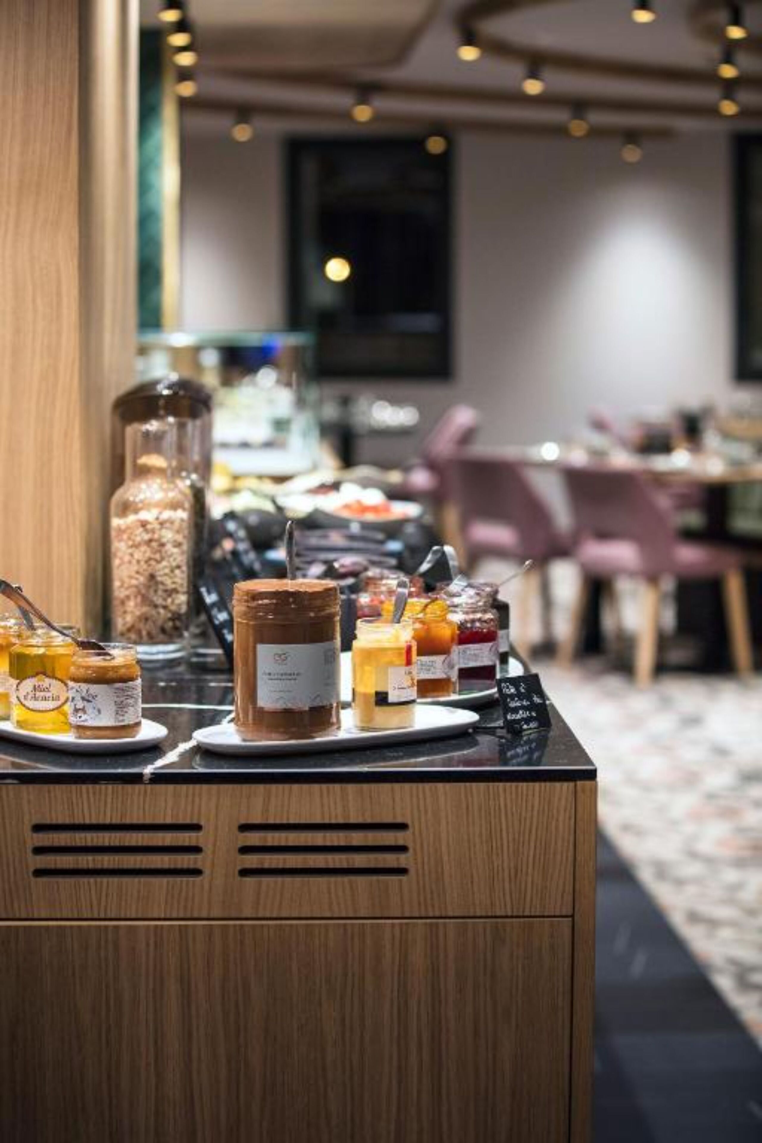 A breakfast buffet with various spreads and condiments.