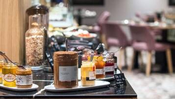 A breakfast buffet with various spreads and condiments.