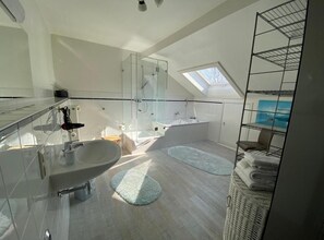 Bathtub, hair dryer, towels, soap