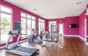 A fitness center with treadmills, elliptical machines, and weight equipment.