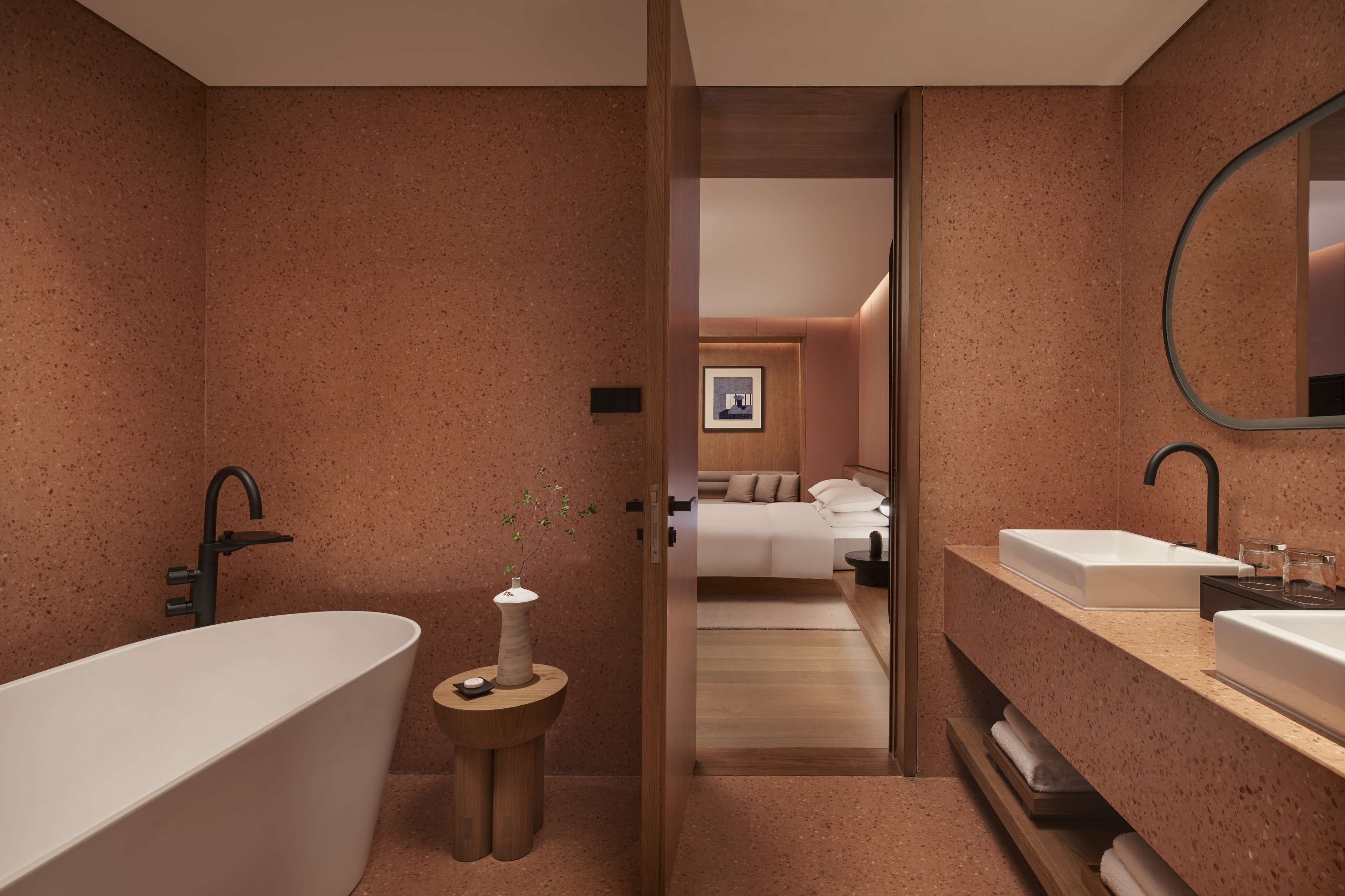 A modern bathroom with a freestanding bathtub, a vanity with a sink, and a mirror.