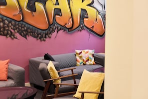 A modern living area with a sofa, armchairs, and a coffee table. - Neuchatel City Hotel (Neuchatel)