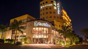 A hotel with a stone facade, multiple balconies, and a prominent sign.
