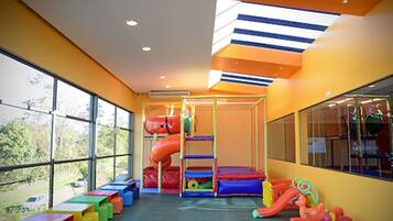 Children can play safely in this enclosed play area featuring slides, tunnels, and soft surfaces.