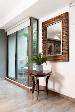 Enjoy a seamless transition to the outdoors through the large sliding glass door, featuring a round table and potted plant.